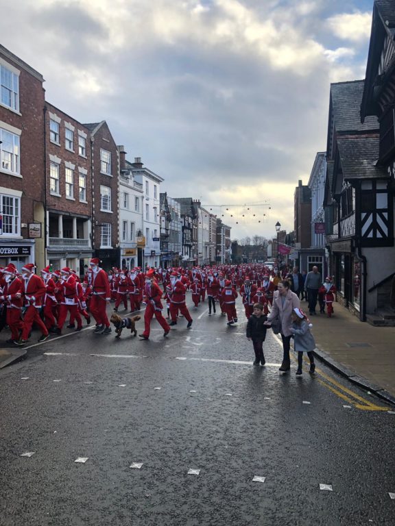 Look at all those Santas! A sea of Santas dashing up Lowe Bridge Street, Chester