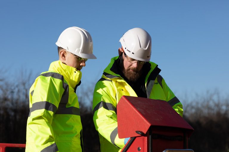 Two engineers working to prevent flooding