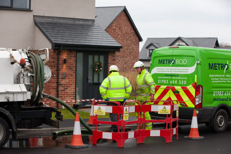Engineers doing drainage work on a house