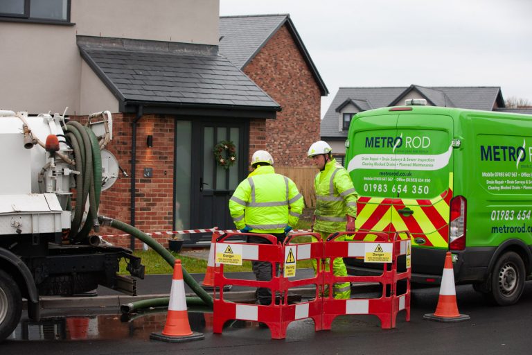 Engineers doing drainage work on a house